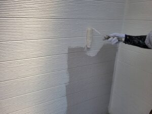 秦野市N様邸 外壁中塗り作業 白とベージュの塗り分けを進める職人の施工風景